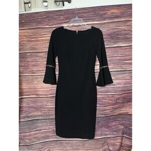 Calvin Klein Black Dress Size 2 Fitted with 3/4 Bell Sleeve With gold Rings.